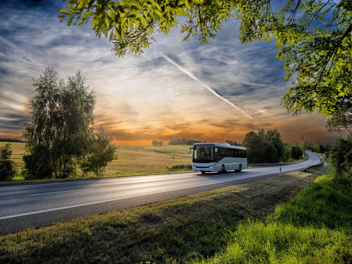 Alma Air Bus coach travelling on a Kenyan road at sunset